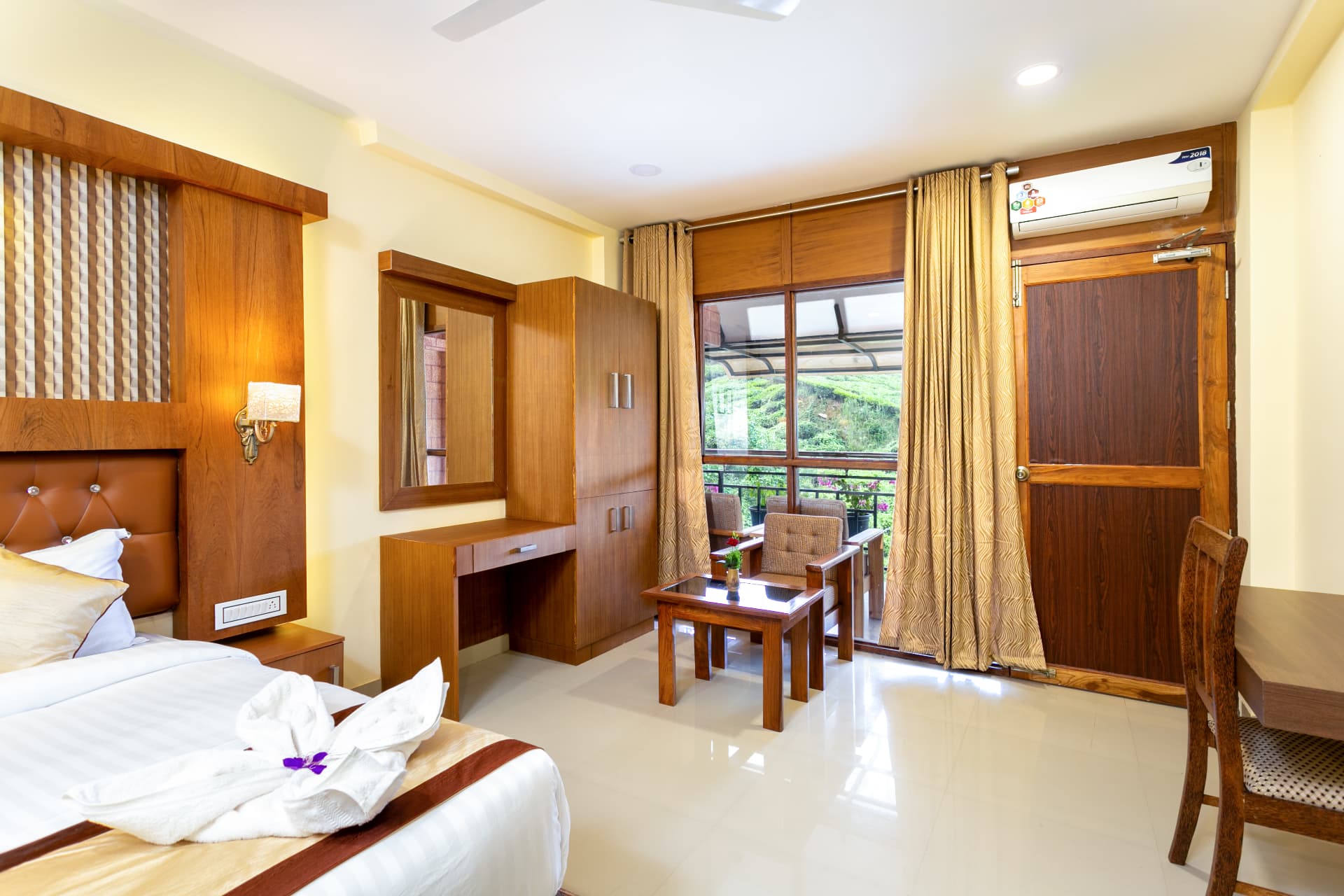 Premium Valley View Room seen wide, with dressing table, wardrobe and balcony seating