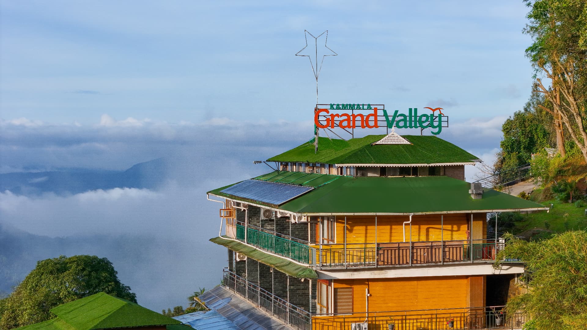 Kammala Grand Valley rooftop signage with a sea of clouds filling the valley below