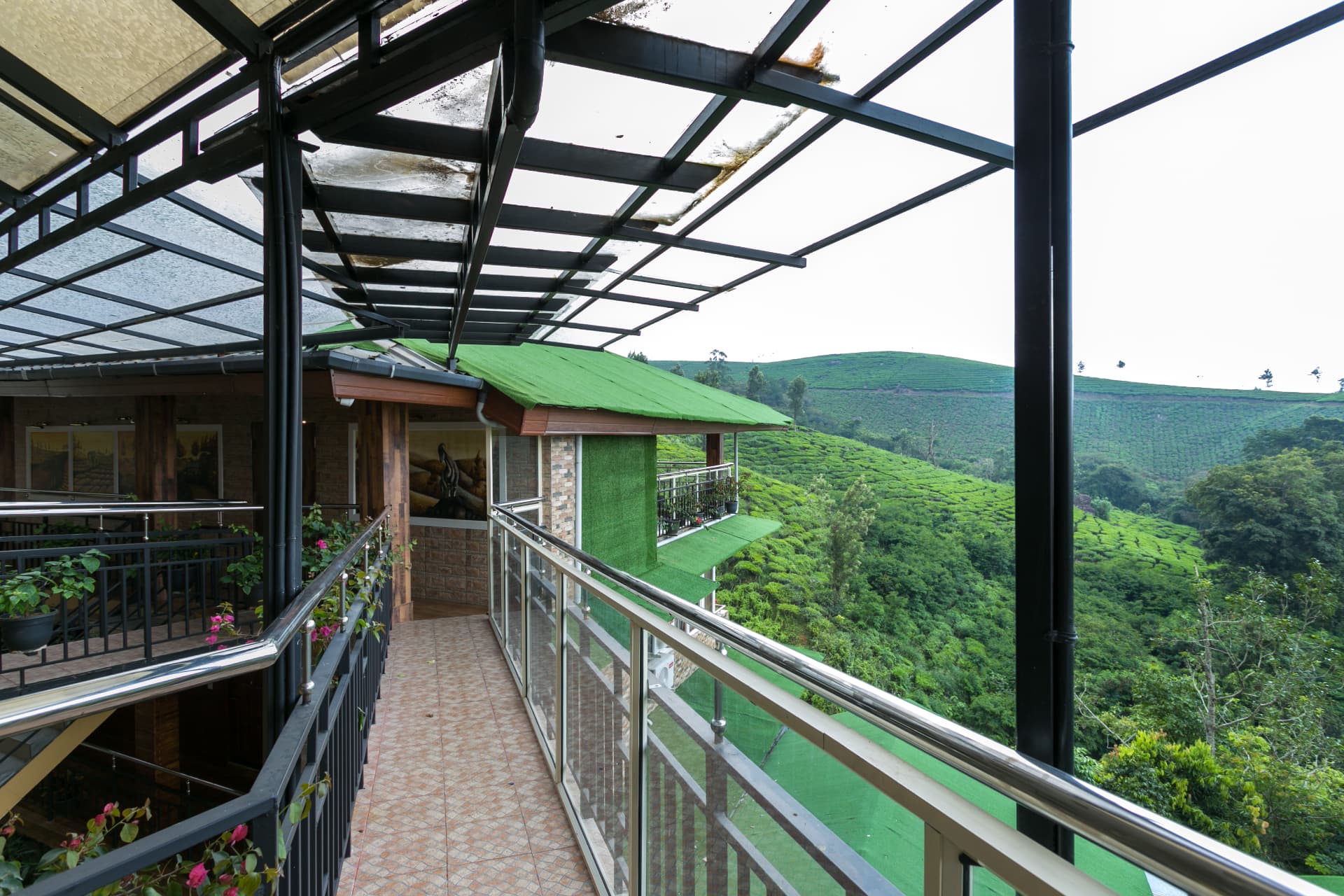 Walkway outside the Deluxe Non Valley View Rooms, green roofs and the hills beyond