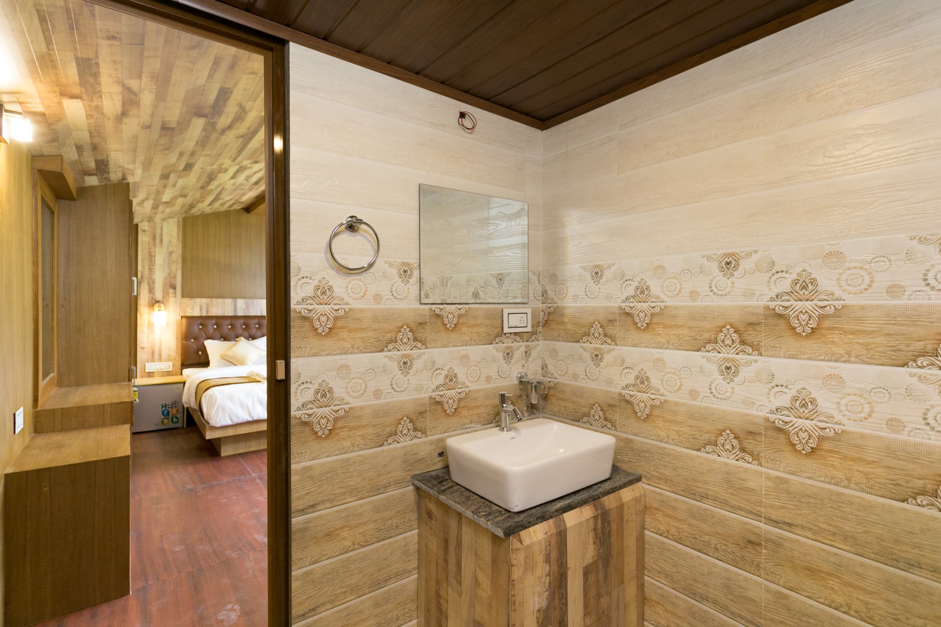 Wood-clad bathroom of the Family Suite Hut with vanity and mirror