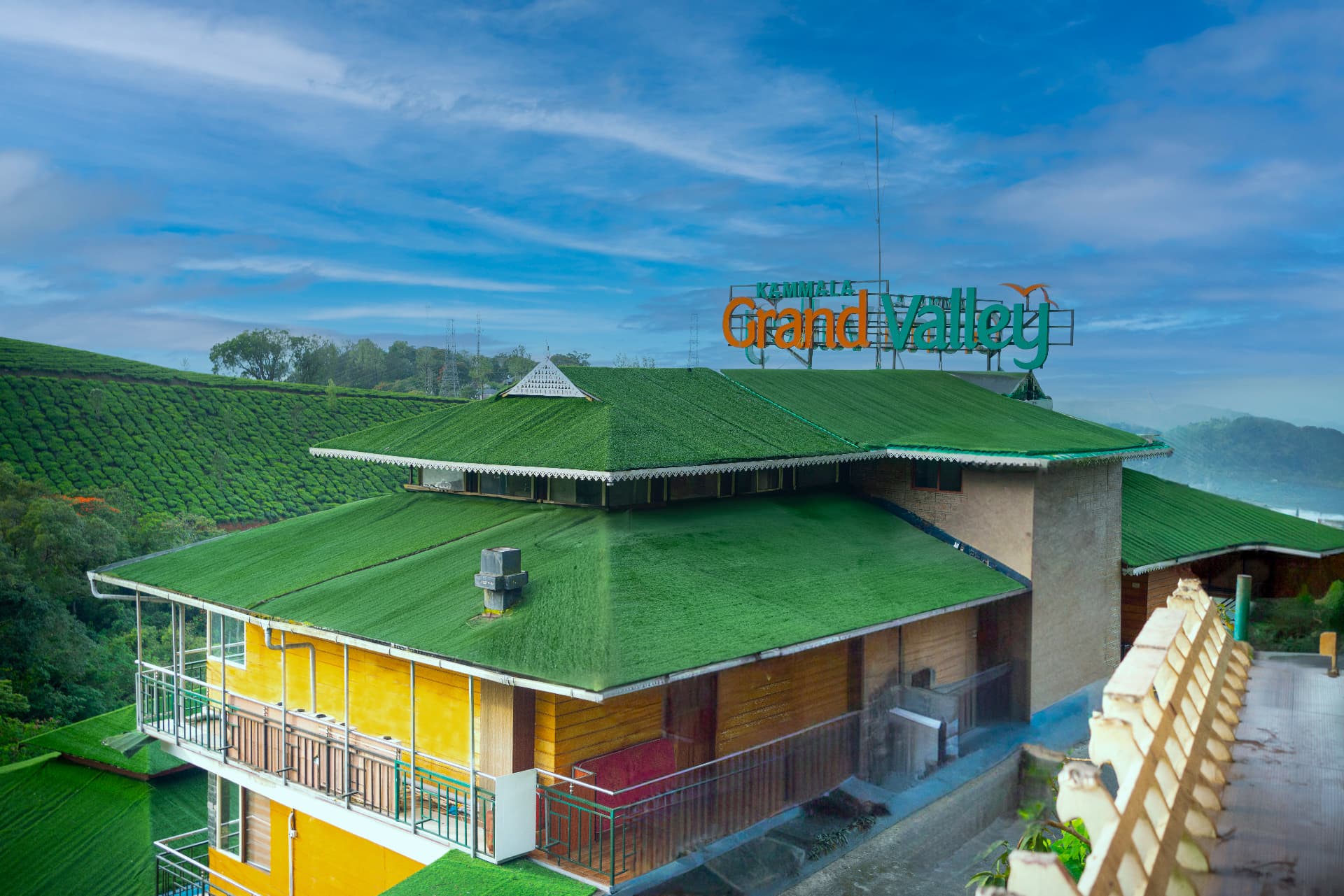 Green roofs of Grand Valley Resort stepping down the Munnar hillside